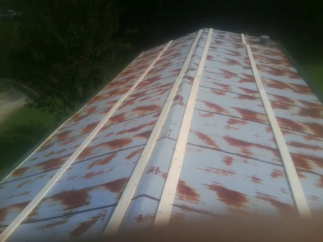 Rusted metal roof panels with new wood purlins before replacement — Storm Damage Roof Repair in Yeagertown by Roofing Brothers