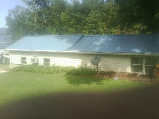 Blue metal roof running the length of a single story home in Yeagertown
